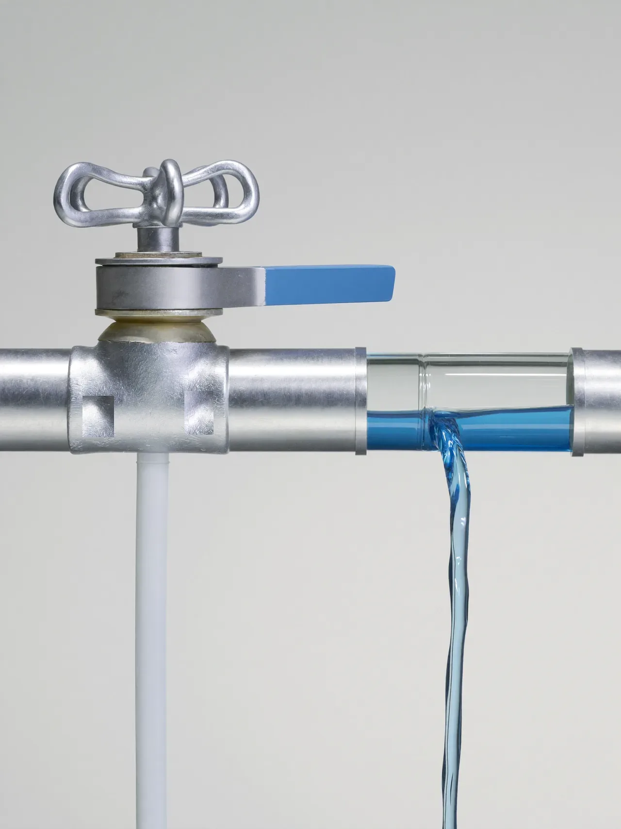 The line runs itself; one hand-set valve decides what passes.