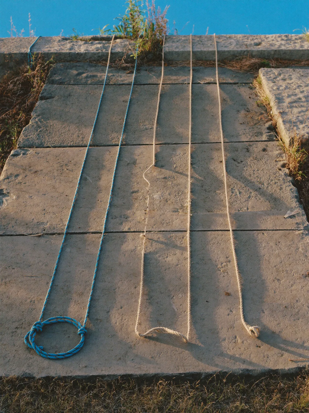 Most of the line holds; one strand has gone slack.